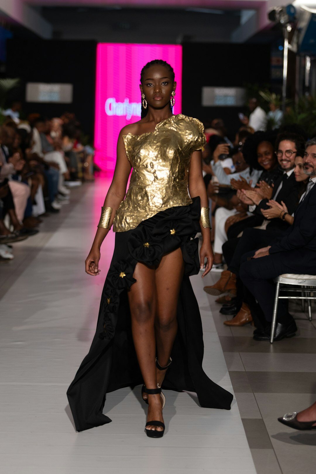 Woman in a couture dress captured mid-motion on a runway